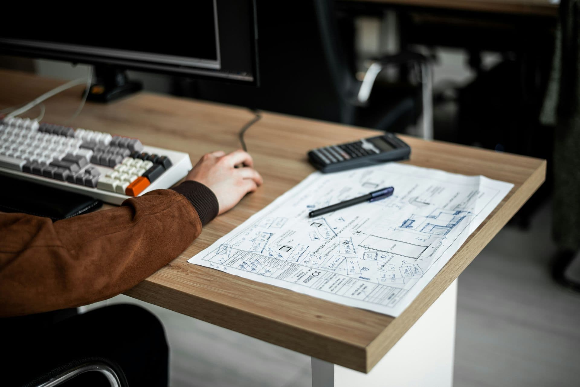 Person drawing at a desk